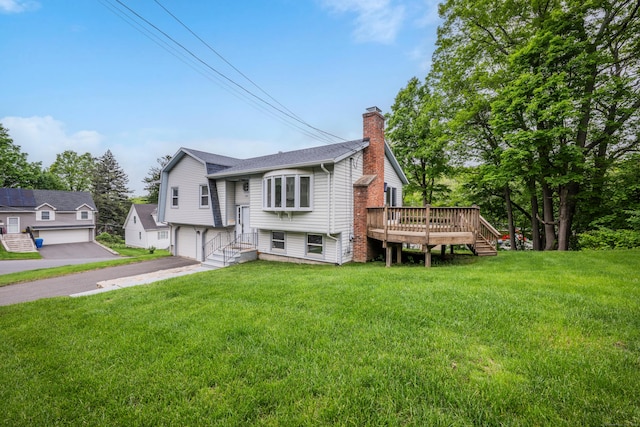 154 Williamson Dr, Waterbury, CT 06710 - view of front facade with a chimney, a garage, a wooden deck, and a front lawn