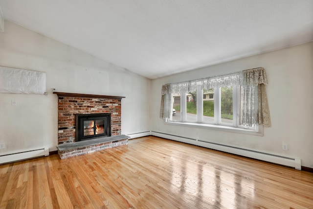 154 Williamson Dr, Waterbury, CT 06710 - unfurnished living room featuring baseboard heating, lofted ceiling, wood finished floors, a baseboard heating unit, and a fireplace