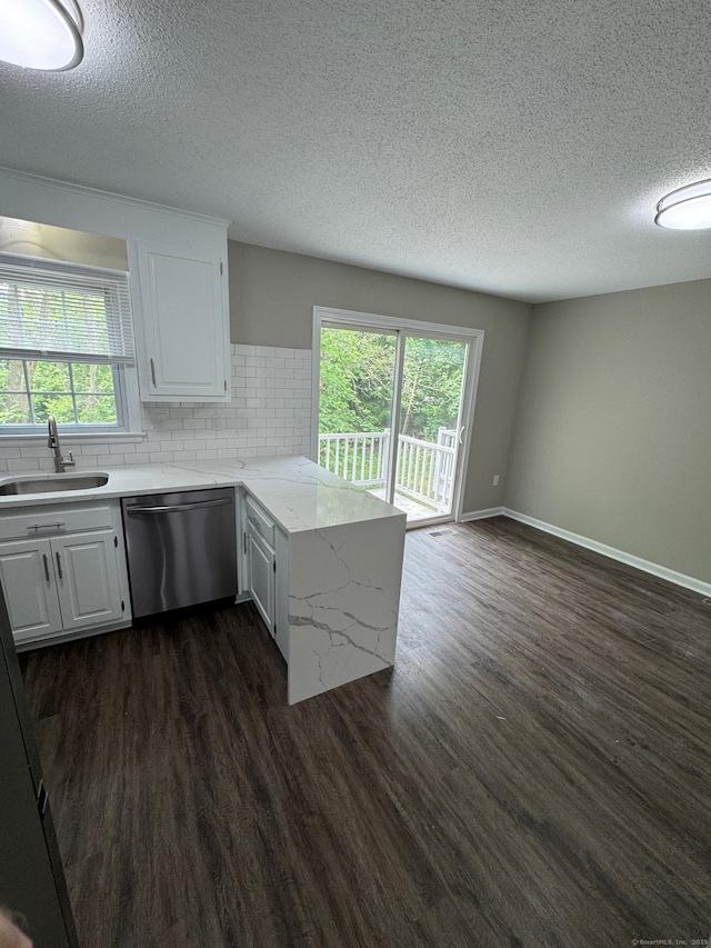 222 W Main St Apt 1C, Southington, CT 06479 - kitchen featuring a sink, dishwasher, a peninsula, a textured ceiling, and dark wood-type flooring