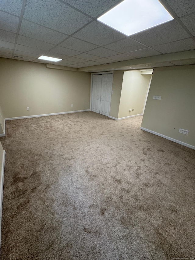 222 W Main St Apt 1C, Southington, CT 06479 - finished below grade area with a paneled ceiling, carpet flooring, and baseboards