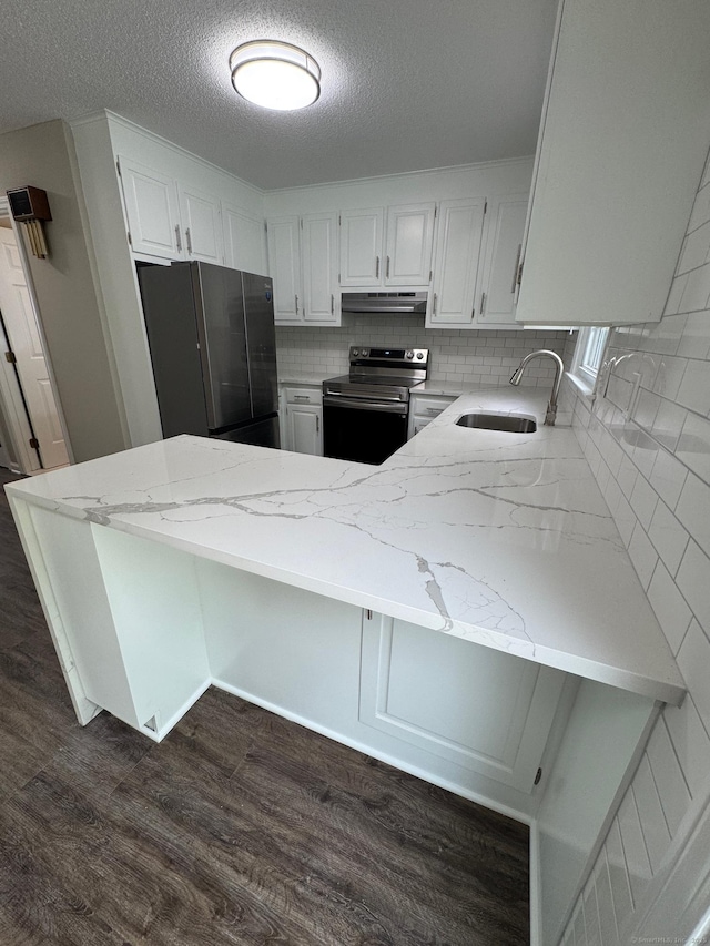222 W Main St Apt 1C, Southington, CT 06479 - kitchen featuring appliances with stainless steel finishes, a sink, light stone countertops, a peninsula, and a textured ceiling