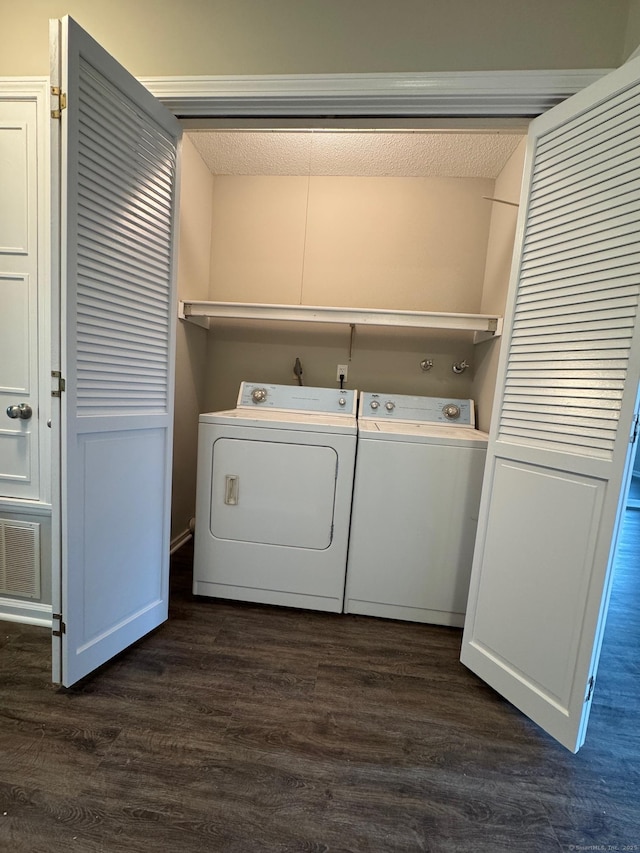 222 W Main St Apt 1C, Southington, CT 06479 - laundry area with washing machine and clothes dryer, dark wood-style flooring, and a textured ceiling