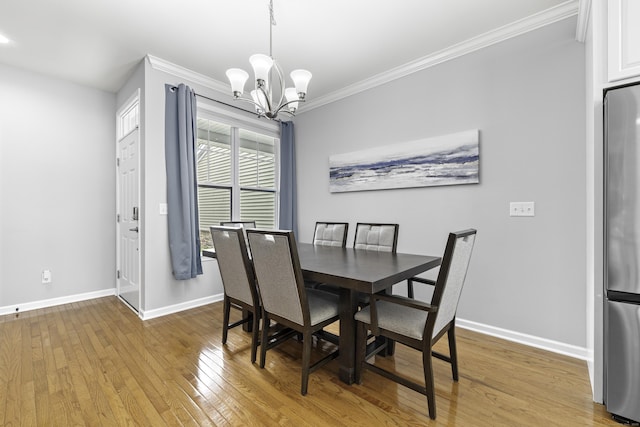 81 Tucker St Unit 81, Danbury, CT 06810 - dining space featuring a chandelier, baseboards, ornamental molding, and light wood finished floors