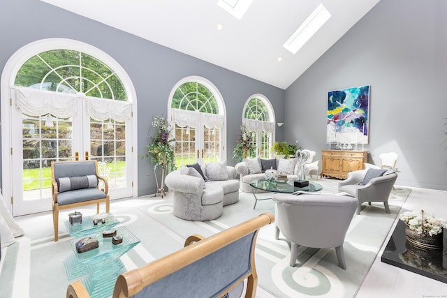 living area with high vaulted ceiling, a skylight, plenty of natural light, baseboards, and recessed lighting