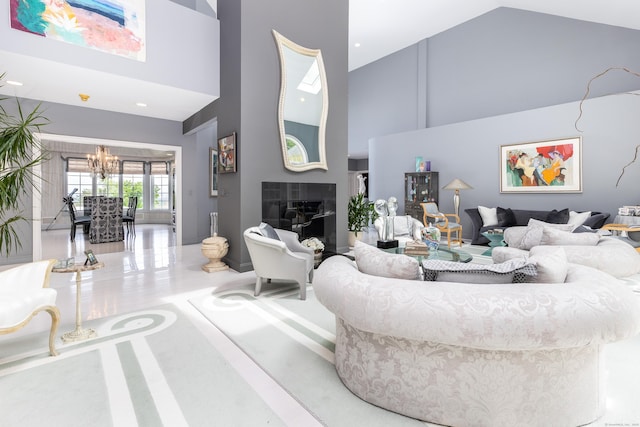 living area with high vaulted ceiling, a chandelier, and a fireplace