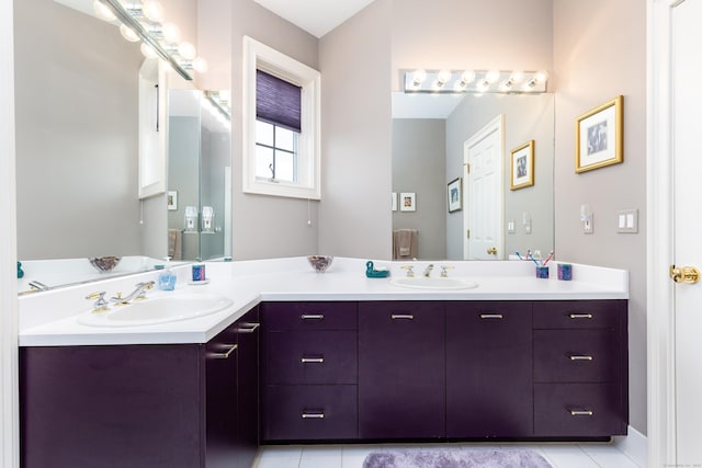 full bath with double vanity and tile patterned flooring