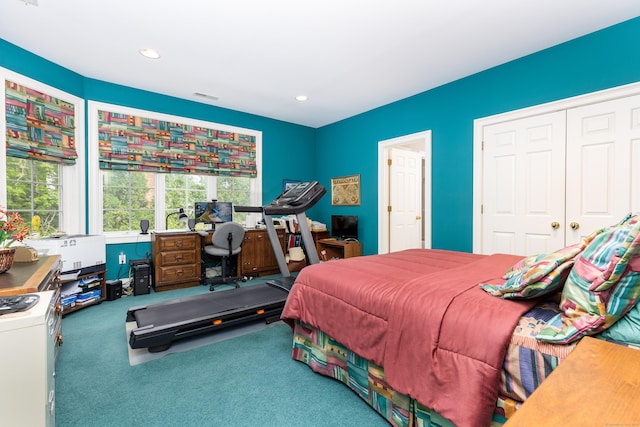 carpeted bedroom with a closet and recessed lighting
