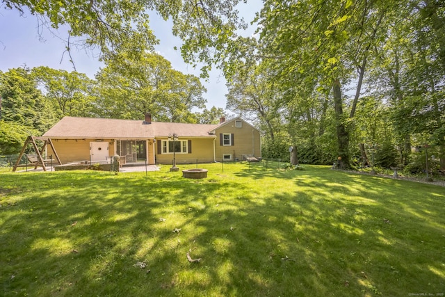 15 Kings Hwy, North Haven, CT 06473 - rear view of house with a patio, an outdoor fire pit, a lawn, and a chimney