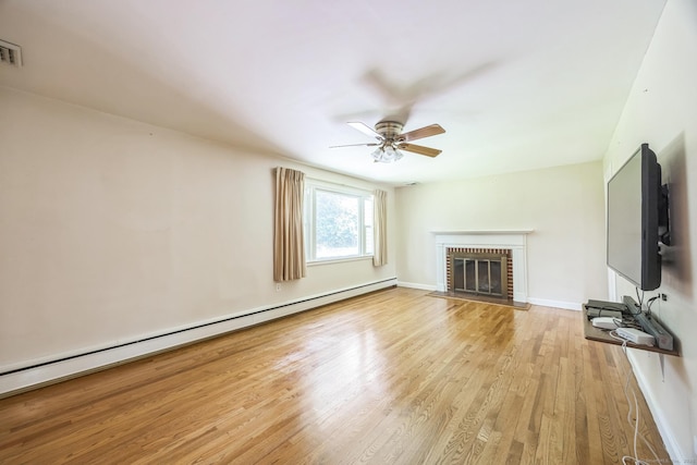 15 Kings Hwy, North Haven, CT 06473 - unfurnished living room featuring baseboard heating, wood finished floors, ceiling fan, and a brick fireplace