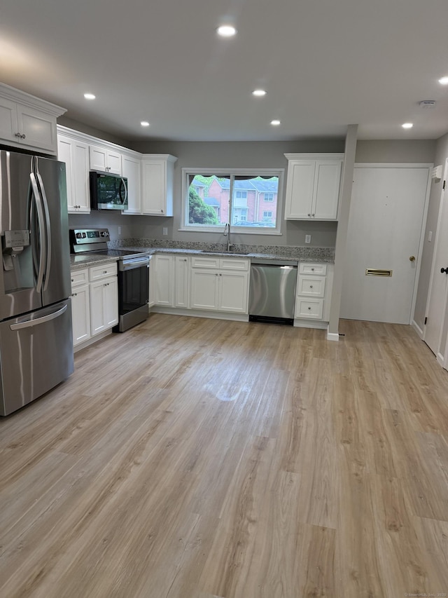 240 Centerbrook Rd Unit 240, Hamden, CT 06518 - kitchen featuring appliances with stainless steel finishes, white cabinets, a sink, light wood-type flooring, and recessed lighting