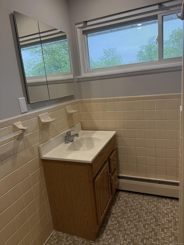 240 Centerbrook Rd Unit 240, Hamden, CT 06518 - bathroom with a baseboard heating unit, tile walls, vanity, wainscoting, and tile patterned flooring