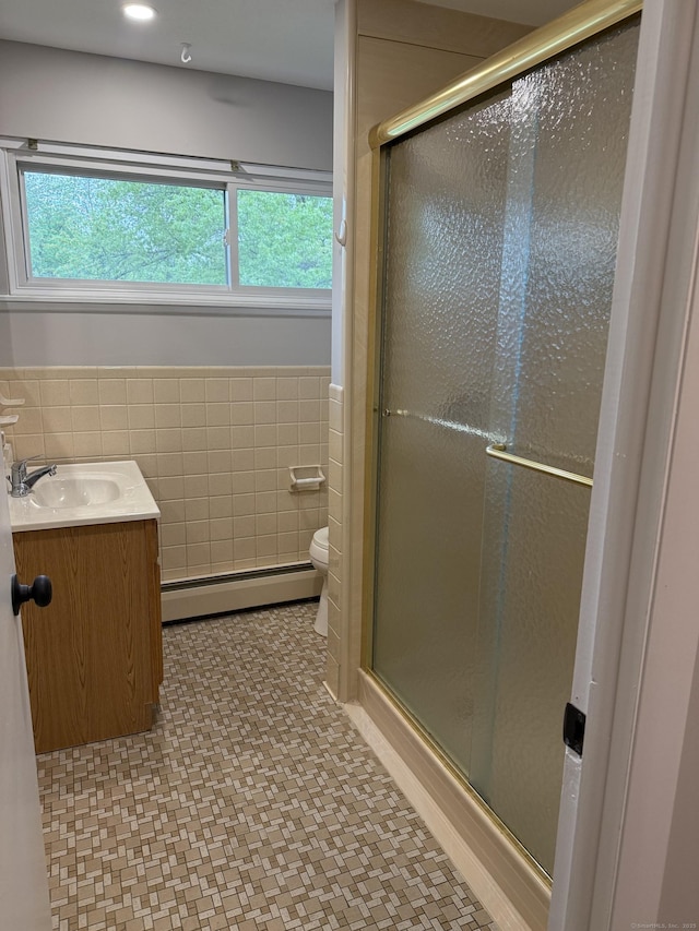240 Centerbrook Rd Unit 240, Hamden, CT 06518 - bathroom featuring baseboard heating, tile walls, a wainscoted wall, a shower stall, and toilet
