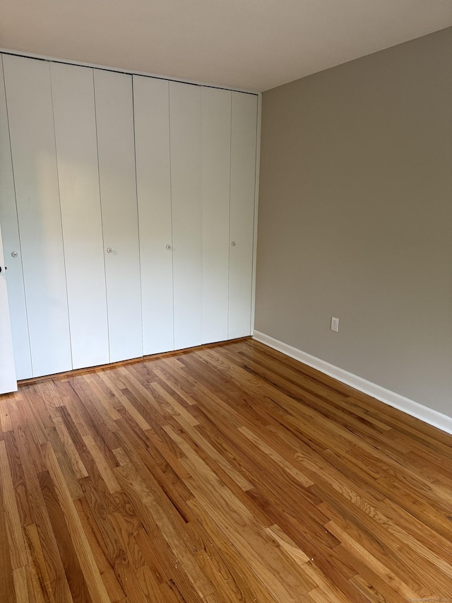 240 Centerbrook Rd Unit 240, Hamden, CT 06518 - unfurnished bedroom with wood finished floors, baseboards, and a closet