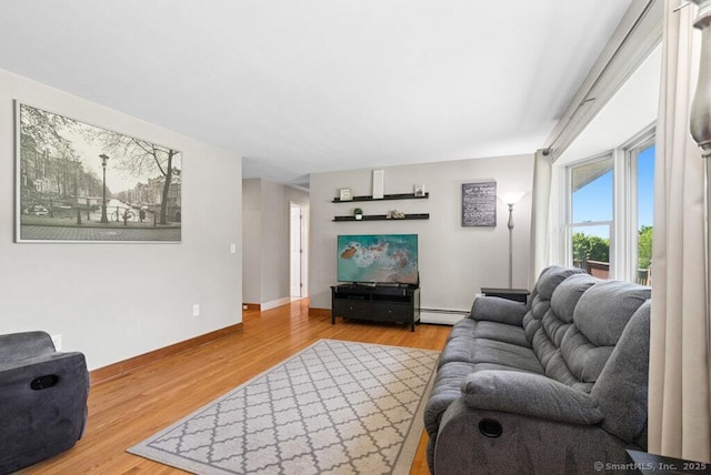 26 Thorson Rd, Oxford, CT 06478 - living area with a baseboard heating unit, wood finished floors, and baseboards