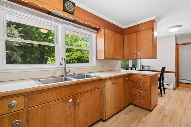 26 Thorson Rd, Oxford, CT 06478 - kitchen featuring a sink, light wood-style floors, a baseboard heating unit, brown cabinets, and light countertops