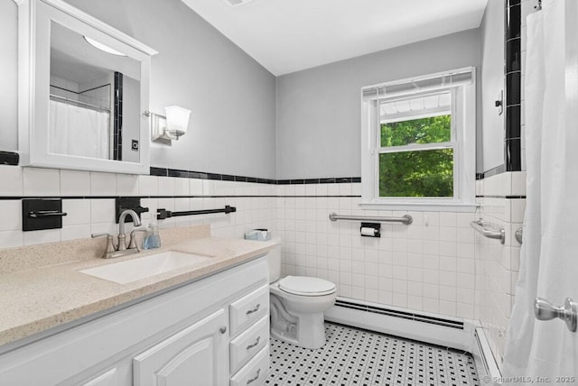 26 Thorson Rd, Oxford, CT 06478 - full bath featuring baseboard heating, vanity, a wainscoted wall, toilet, and tile walls