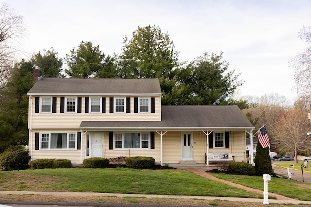 65 Lufkin Ln, Bristol, CT 06010 - view of front of property with a front yard, a porch, and a chimney