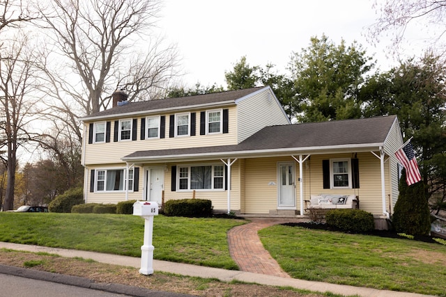 65 Lufkin Ln, Bristol, CT 06010 - view of front of home featuring a porch, a chimney, and a front lawn