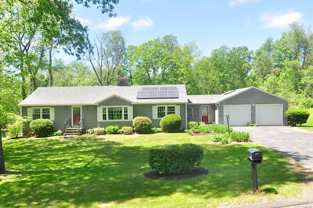 142 Case St, Canton, CT 06019 - single story home with an attached garage, roof mounted solar panels, asphalt driveway, a front lawn, and a chimney