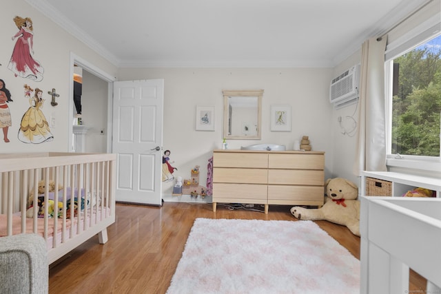 48 Twin Oaks Unit 48, New Milford, CT 06776 - bedroom featuring wood finished floors, ornamental molding, a wall mounted AC, and a crib