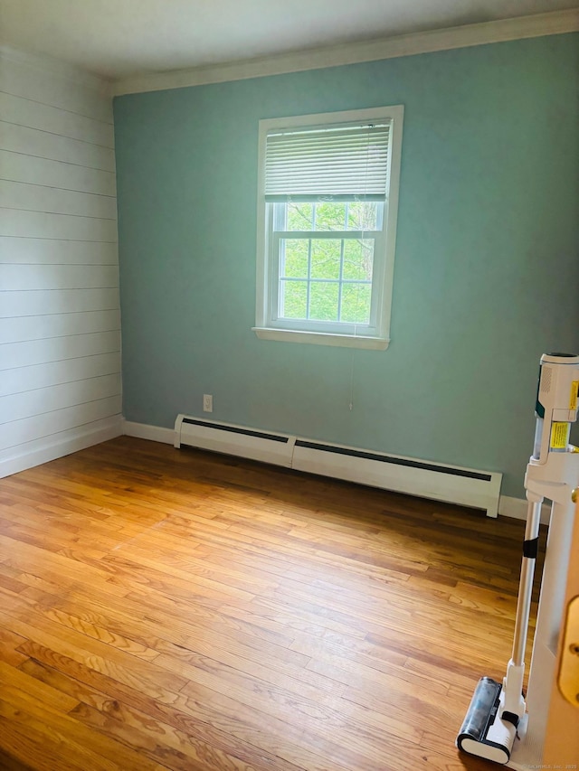23 Dana Rd, Danbury, CT 06811 - unfurnished bedroom with baseboard heating, light wood-style flooring, ornamental molding, and baseboards
