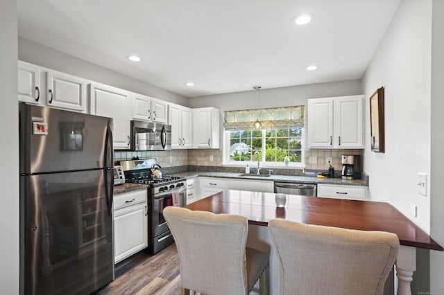 560 Silver Sands Rd Unit 902, East Haven, CT 06512 - kitchen with appliances with stainless steel finishes, a sink, dark countertops, white cabinetry, and recessed lighting