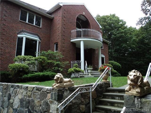 501 Woodbine Rd, Stamford, CT 06903 - back of property featuring a balcony and brick siding