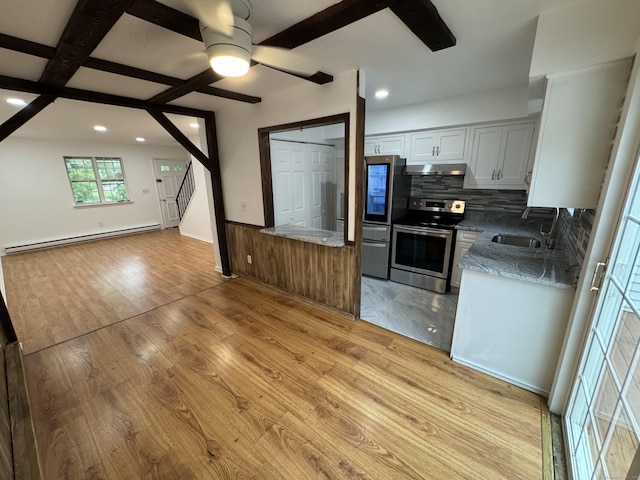 103 Kohanza St Unit E, Danbury, CT 06811 - kitchen with stainless steel appliances, a baseboard radiator, open floor plan, under cabinet range hood, and tasteful backsplash