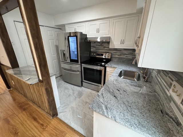 103 Kohanza St Unit E, Danbury, CT 06811 - kitchen featuring appliances with stainless steel finishes, extractor fan, light stone countertops, and white cabinets