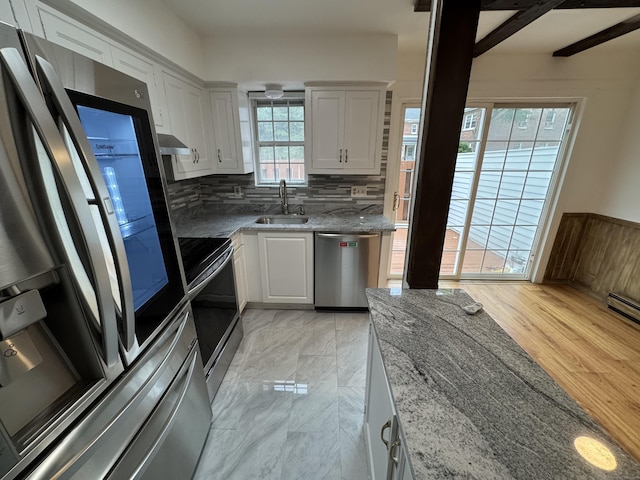 103 Kohanza St Unit E, Danbury, CT 06811 - kitchen with stainless steel appliances, a sink, white cabinets, and light stone counters