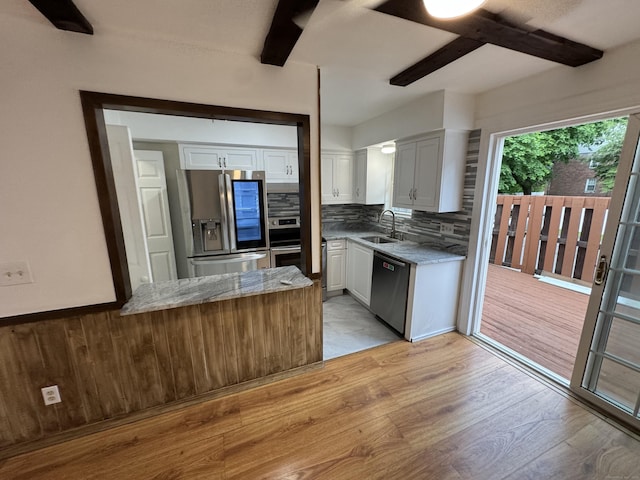 103 Kohanza St Unit E, Danbury, CT 06811 - kitchen with stainless steel appliances, a sink, tasteful backsplash, light wood-type flooring, and light stone countertops