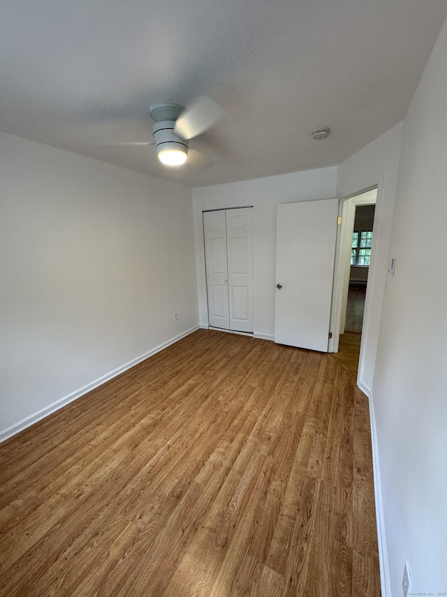 103 Kohanza St Unit E, Danbury, CT 06811 - unfurnished bedroom featuring wood finished floors, a closet, a ceiling fan, and baseboards