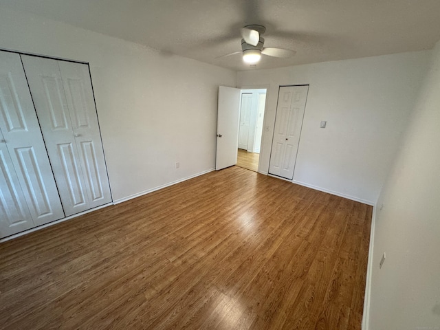 103 Kohanza St Unit E, Danbury, CT 06811 - unfurnished bedroom with wood finished floors, baseboards, and ceiling fan