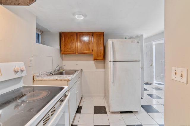 4 Granite St, Waterbury, CT 06706 - kitchen featuring white appliances, a sink, brown cabinets, light countertops, and light tile patterned floors