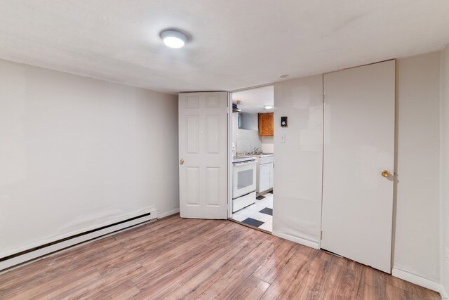 4 Granite St, Waterbury, CT 06706 - unfurnished bedroom with a baseboard radiator, light wood-style floors, ensuite bathroom, and a sink