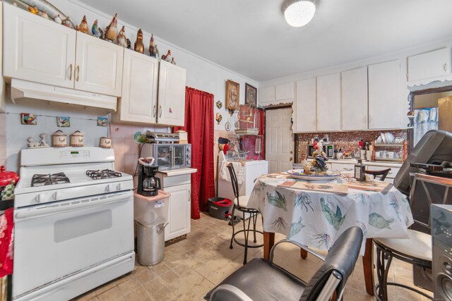 4 Granite St, Waterbury, CT 06706 - kitchen featuring gas range gas stove, under cabinet range hood, white cabinetry, backsplash, and crown molding