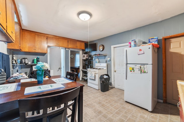 4 Granite St, Waterbury, CT 06706 - kitchen featuring white appliances, brown cabinetry, and light floors
