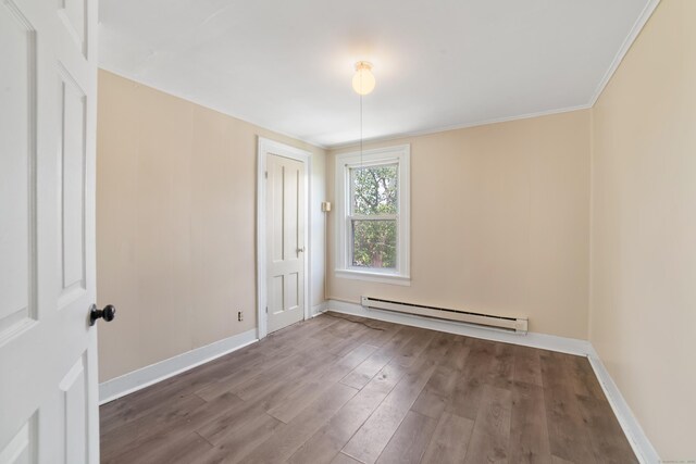 4 Granite St, Waterbury, CT 06706 - empty room with baseboard heating, wood finished floors, baseboards, and ornamental molding