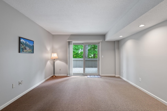 empty room with carpet, a textured ceiling, baseboards, and recessed lighting