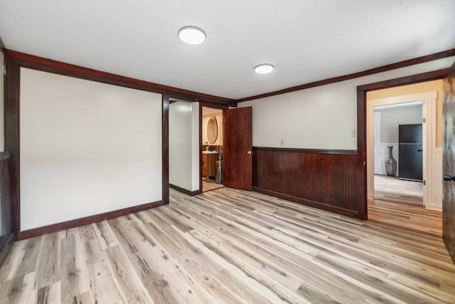 253 N Main St, Norwich, CT 06360 - spare room with wainscoting, light wood-type flooring, and crown molding