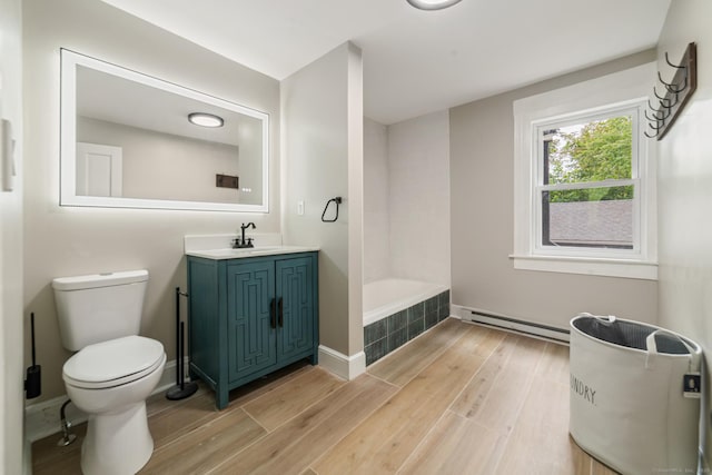 253 N Main St, Norwich, CT 06360 - bathroom featuring baseboard heating, tiled tub, toilet, and wood finished floors