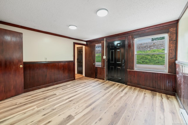 253 N Main St, Norwich, CT 06360 - spare room with a textured ceiling, wood finished floors, wood walls, ornamental molding, and a wainscoted wall