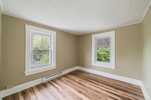 253 N Main St, Norwich, CT 06360 - spare room featuring plenty of natural light, light wood-type flooring, baseboard heating, baseboards, and ornamental molding