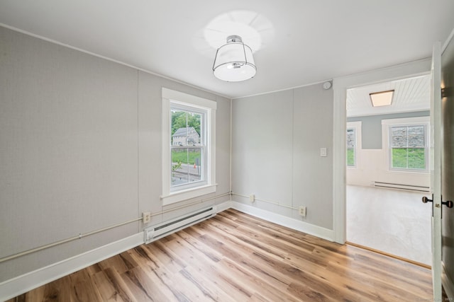 253 N Main St, Norwich, CT 06360 - spare room featuring baseboard heating, light wood-type flooring, and baseboards