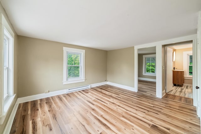 253 N Main St, Norwich, CT 06360 - unfurnished room featuring a baseboard heating unit, light wood-type flooring, and healthy amount of natural light