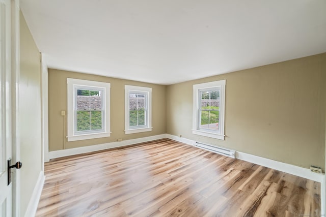 253 N Main St, Norwich, CT 06360 - unfurnished room featuring baseboard heating, light wood-type flooring, and baseboards