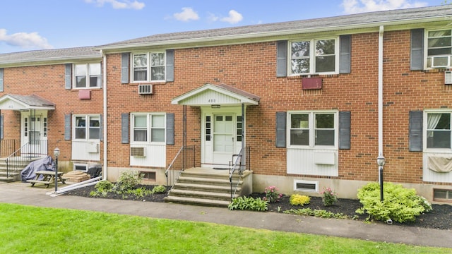 480 Radmere Rd Unit A, Cheshire, CT 06410 - townhome / multi-family property with brick siding, a wall mounted AC, and cooling unit
