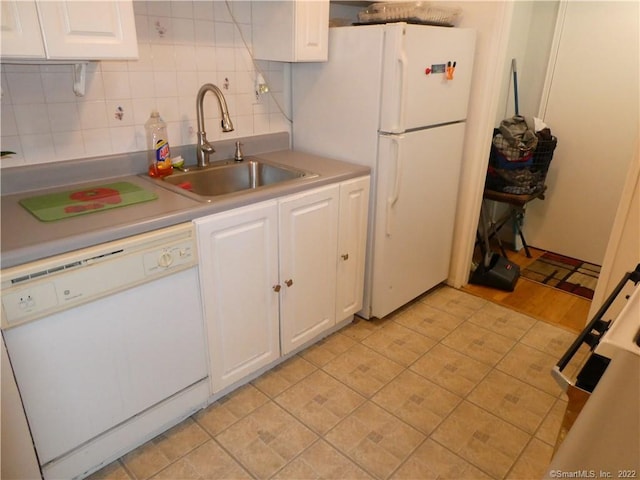 125 Prospect St Unit 3C, Stamford, CT 06901 - kitchen with white appliances, a sink, white cabinets, and decorative backsplash