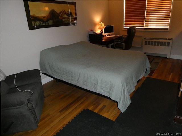 125 Prospect St Unit 3C, Stamford, CT 06901 - bedroom with radiator, wood finished floors, and baseboards