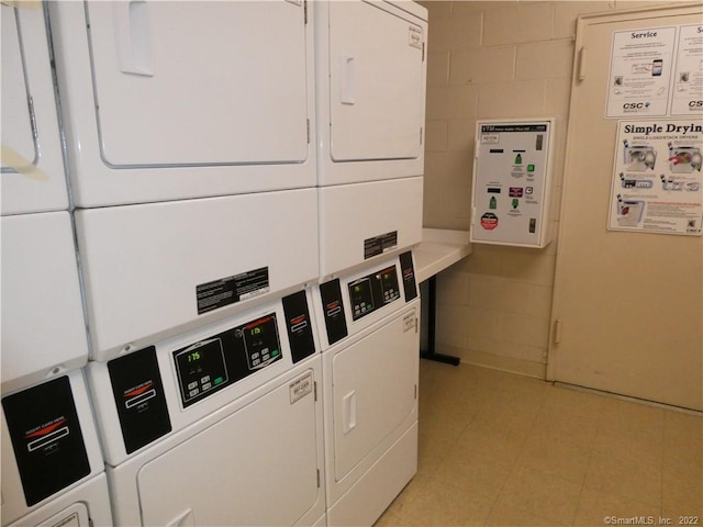 125 Prospect St Unit 3C, Stamford, CT 06901 - communal laundry room with stacked washer and clothes dryer, concrete block wall, and washer and clothes dryer